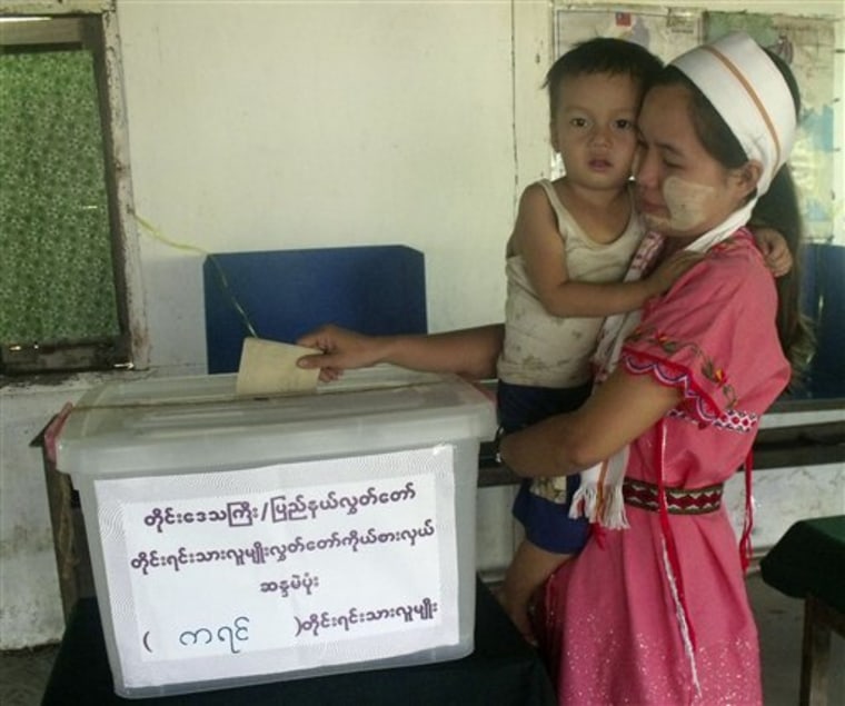 A Karen ethnic woman casts an advance vote at a local election commission office Saturday in Yangon, Myanmar. Opposition party officials say Myanmar's pro-junta party has told voters they could lose their jobs if they fail to vote for military-backed candidates in Sunday's elections, casting more doubt on the legitimacy of the nation's first ballot in 20 years.